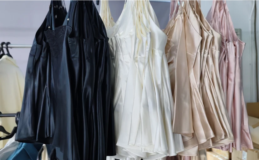Hanging silk loungewear in black, white, and pink colors
