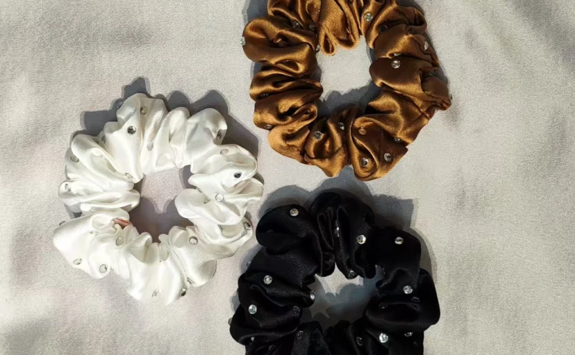 Custom rhinestone-embellished silk scrunchies in white, black, and gold colors