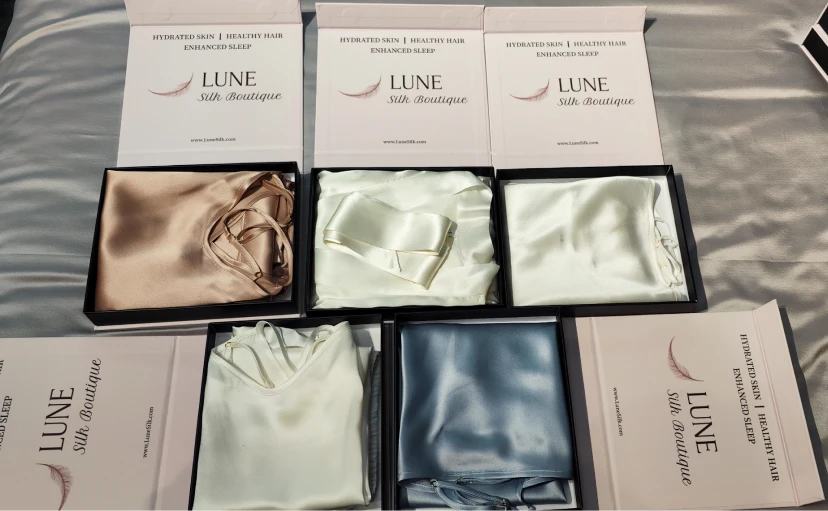 Full LUNE silk collection including robes, camisoles, and pillowcases in custom boxes
