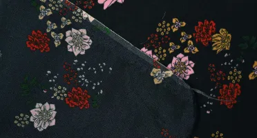 Black silk crepe de chine fabric showing matte pebbled texture