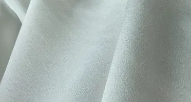White silk CDC fabric close-up with subtle crepe surface