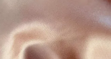 Ivory stretch silk fabric swatch in soft neutral tone