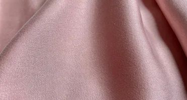 Blush pink stretch silk fabric detail with gentle stretch