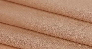 Champagne stretch silk fabric close-up with warm tone