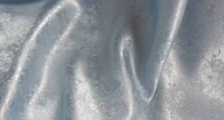 Silver silk jacquard fabric with light-catching woven surface