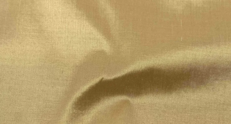Gold silk dupioni fabric with warm metallic tone